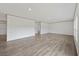 Spacious open-concept living room with light-colored walls, trim, and light wood-look flooring at 7019 Norton Rd., Green Sea, SC 29545