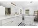 Bright bathroom featuring marble countertops, double vanity, and a soaking tub with mosaic tile accents at 709 Yucca Ave., Myrtle Beach, SC 29577