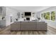 Bright living room features a large sectional sofa, wood floors, and a fireplace with built-in shelving at 709 Yucca Ave., Myrtle Beach, SC 29577