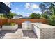 This outdoor kitchen features a stainless steel grill, white brick surround, and a bar for outdoor dining at 709 Yucca Ave., Myrtle Beach, SC 29577