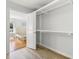 An open closet shows its design and storage space, leading to a bedroom with hardwood floors at 709 Yucca Ave., Myrtle Beach, SC 29577