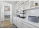 Bright hallway with built-in cabinets and shelves offers ample storage space, seamlessly connecting to a mudroom at 709 Yucca Ave., Myrtle Beach, SC 29577