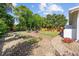 Lush backyard with a fire pit area surrounded by Adirondack chairs and manicured landscaping offers a relaxing retreat at 709 Yucca Ave., Myrtle Beach, SC 29577