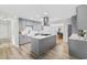 Open concept kitchen with gray cabinets, stainless appliances, an island, and views to the dining room at 709 Yucca Ave., Myrtle Beach, SC 29577