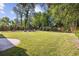Expansive backyard with a fire pit and lush greenery offers a serene retreat for relaxation and outdoor activities at 709 Yucca Ave., Myrtle Beach, SC 29577