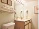 Well-lit bathroom featuring a vanity, sink, toilet, and storage space for toiletries and towels at 7100 N Ocean Blvd. # 621, Myrtle Beach, SC 29572