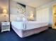 Cozy bedroom with a comfortable bed, nightstand, and access to an ensuite bathroom at 7100 N Ocean Blvd. # 621, Myrtle Beach, SC 29572