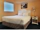 Comfortable bedroom with a full size bed, bedside table, and a window at 7100 N Ocean Blvd. # 621, Myrtle Beach, SC 29572