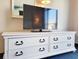 White dresser with six drawers offering ample storage space underneath a wall-mounted TV at 7100 N Ocean Blvd. # 621, Myrtle Beach, SC 29572