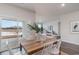 Open dining area with a wooden table, white chairs, sliding glass doors, and a view of the backyard at 7367 Meadow Walk Loop, Loris, SC 29569