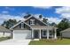 Charming single-Gathering home with a two-car garage, covered entryway and well-maintained lawn at 7367 Meadow Walk Loop, Loris, SC 29569