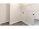 Empty laundry room with gray vinyl flooring and a wire rack for storage at 7367 Meadow Walk Loop, Loris, SC 29569