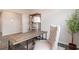 Stylish office space with a wood desk, chair, shelving unit and decorative plant at 7367 Meadow Walk Loop, Loris, SC 29569