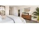 Tranquil bedroom featuring hardwood floors, a large mirror, natural light, and a calming decor at 7399 Meadow Walk Loop, Loris, SC 29569