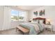 Cozy bedroom with a wicker headboard, bench, and view from the bright window at 7399 Meadow Walk Loop, Loris, SC 29569