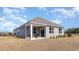 Rear exterior view of a home featuring neutral siding and a covered patio space at 7399 Meadow Walk Loop, Loris, SC 29569
