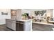 Open-concept kitchen with granite countertops, stainless steel appliances, and seamless flow into the living room at 7399 Meadow Walk Loop, Loris, SC 29569