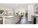 Bright kitchen featuring granite countertops, a large island, stainless steel appliances and hardwood flooring at 7399 Meadow Walk Loop, Loris, SC 29569