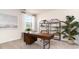 Charming home office space with sleek wooden desk, shelves and a big window at 7399 Meadow Walk Loop, Loris, SC 29569