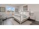 Well-lit bedroom features a four-poster bed with a decorative chair and a view of the outdoors at 7415 Meadow Walk Loop, Loris, SC 29569