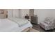 Bedroom showcases a patterned chair, a dresser with a mirror, and a soft green throw on the bed at 7415 Meadow Walk Loop, Loris, SC 29569