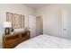 Comfortable bedroom featuring a wooden dresser, modern light fixtures, decorative wall art, and an open doorway at 7415 Meadow Walk Loop, Loris, SC 29569