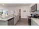 Modern kitchen features granite countertops, stainless steel appliances, and open design into dining and living areas at 7415 Meadow Walk Loop, Loris, SC 29569