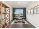 Office space features a patterned accent wall, a desk with chairs, and wooden shelving at 7415 Meadow Walk Loop, Loris, SC 29569