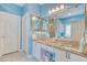 Well lit bathroom with blue walls, granite countertops, double sinks, and a tiled shower and bathtub at 78 Saltwind Loop, Murrells Inlet, SC 29576