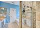 Bathroom with blue walls featuring a granite countertop sink, bathtub, and tiled shower with a glass door at 78 Saltwind Loop, Murrells Inlet, SC 29576