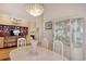 Dining room with chandelier and hardwood floors, adjoining the living space with display cabinets at 78 Saltwind Loop, Murrells Inlet, SC 29576