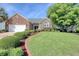 Charming brick home featuring manicured landscaping, healthy green lawn and mature trees at 78 Saltwind Loop, Murrells Inlet, SC 29576