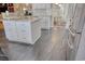 Spacious kitchen with a large island, stainless steel appliances, and modern tile flooring at 78 Saltwind Loop, Murrells Inlet, SC 29576