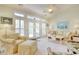 Bright living room with sofa and chairs, complemented by large windows and neutral tones at 78 Saltwind Loop, Murrells Inlet, SC 29576