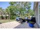 Paver patio with outdoor furniture, manicured lawn, privacy hedges, and mature shade trees in backyard at 78 Saltwind Loop, Murrells Inlet, SC 29576
