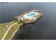 Overhead view of community pool area with lounge chairs and palm trees on an island at 8887 Chandler Dr. # A, Myrtle Beach, SC 29575