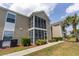 Building exterior featuring a screened-in porch and tidy landscaping with sidewalk access at 8887 Chandler Dr. # A, Myrtle Beach, SC 29575