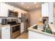 Well-lit kitchen features stainless steel appliances, granite countertops, and ample cabinet space at 8887 Chandler Dr. # A, Myrtle Beach, SC 29575