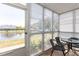 Enclosed lanai with furniture and a view of the water and the community creates a serene and inviting space at 8887 Chandler Dr. # A, Myrtle Beach, SC 29575