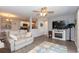 Inviting living area features a cozy fireplace, ceiling fan and open layout at 8887 Chandler Dr. # A, Myrtle Beach, SC 29575