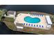 Aerial view of community pool area with a bathhouse and lounge chairs near the lake at 8887 Chandler Dr. # A, Myrtle Beach, SC 29575