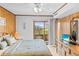 Cozy bedroom featuring wood paneling, a balcony with a view, and beach-themed decor at 9501 Shore Dr. # C-328, Myrtle Beach, SC 29572