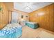 Guest bedroom featuring two twin beds, wood paneling and tropical themed decor at 9501 Shore Dr. # C-328, Myrtle Beach, SC 29572