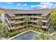 Exterior view of a condo building with lush landscaping and palm trees at 9501 Shore Dr. # C-328, Myrtle Beach, SC 29572