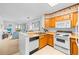 Bright kitchen open to the living area, featuring white appliances and wooden cabinets at 9501 Shore Dr. # C-328, Myrtle Beach, SC 29572