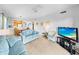 Bright living room with kitchen access, comfortable sofas, and a television for relaxation at 9501 Shore Dr. # C-328, Myrtle Beach, SC 29572