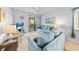 Cozy living room with a plush blue sofa, wicker accents, and access to the balcony at 9501 Shore Dr. # C-328, Myrtle Beach, SC 29572