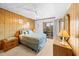 Comfortable bedroom with a bed, wood paneling, natural light and access to balcony at 9501 Shore Dr. # C-328, Myrtle Beach, SC 29572