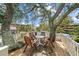 Charming outdoor seating area with a table and chairs under a mature shade tree at 9501 Shore Dr. # C-328, Myrtle Beach, SC 29572