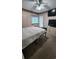 Bedroom with carpet flooring, TV, dresser, ceiling fan and access to outdoor porch at 9540 Shore Dr. # 1N, Myrtle Beach, SC 29572